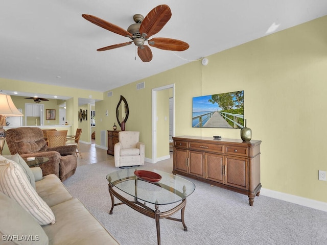 carpeted living room featuring ceiling fan