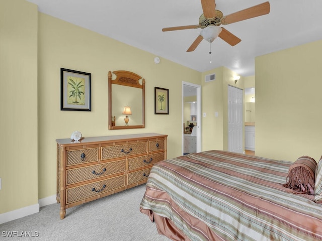 carpeted bedroom featuring connected bathroom, a closet, and ceiling fan