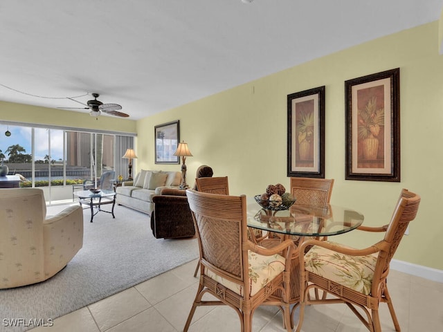 dining space featuring light tile patterned floors and ceiling fan