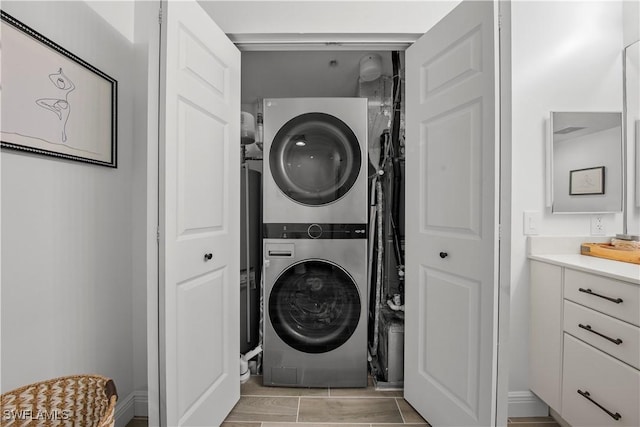 clothes washing area featuring stacked washer and dryer