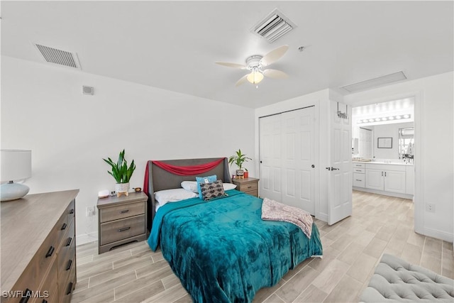 bedroom with connected bathroom, light hardwood / wood-style flooring, a closet, and ceiling fan