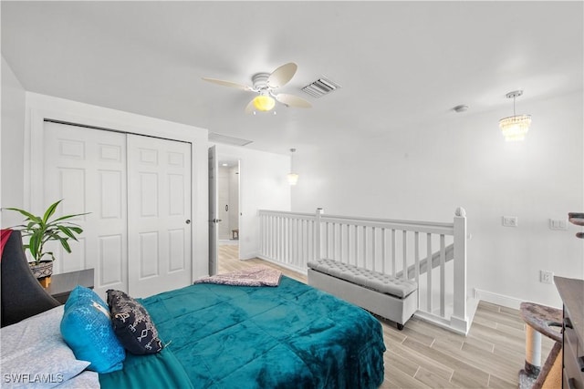 bedroom featuring a closet, ceiling fan, and light hardwood / wood-style floors