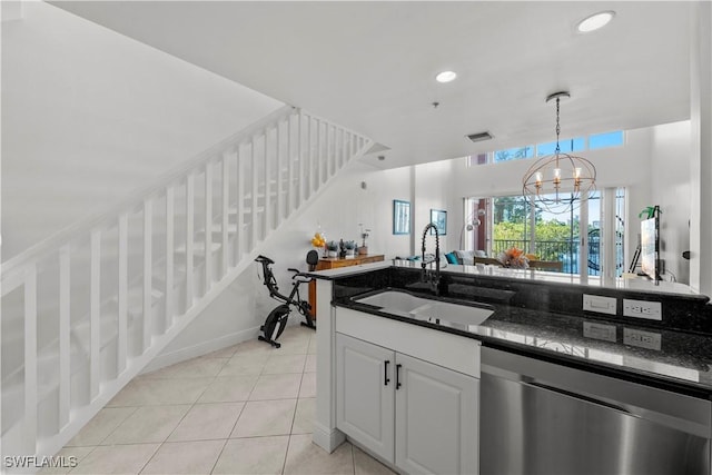 kitchen featuring dishwasher, sink, white cabinets, a notable chandelier, and light tile patterned floors