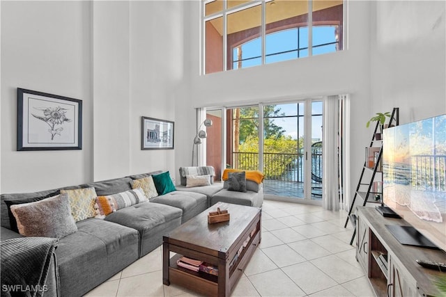 tiled living room featuring a high ceiling