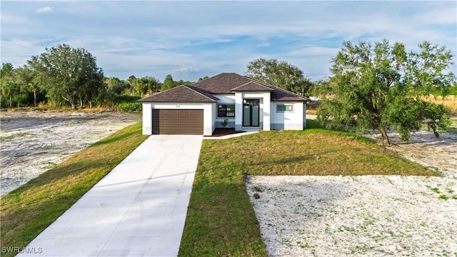 view of front of home with a garage and a front yard