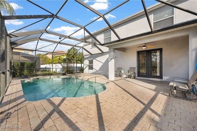 view of pool featuring ceiling fan, french doors, a patio area, and glass enclosure