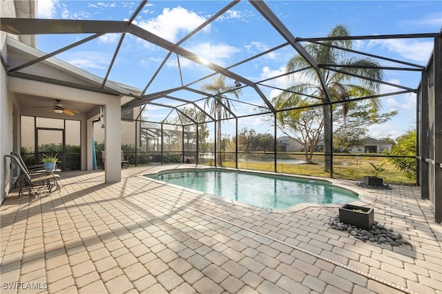 view of swimming pool featuring a lanai, ceiling fan, and a patio