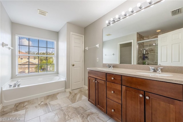 bathroom featuring vanity and independent shower and bath