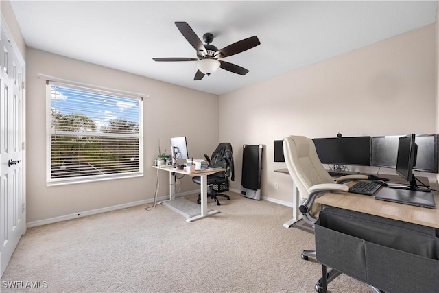 carpeted office space with ceiling fan