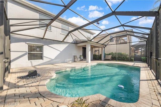 outdoor pool with a patio area and a lanai