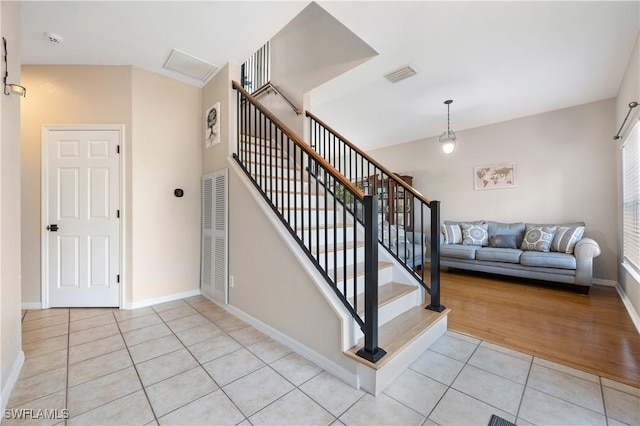 stairs featuring tile patterned floors