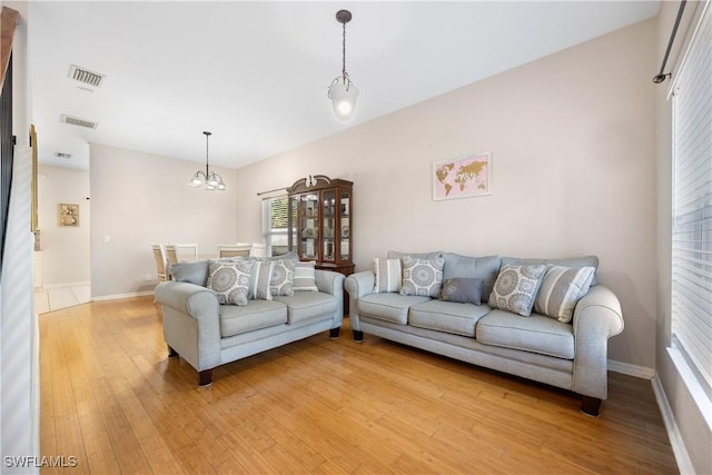 living room with an inviting chandelier and hardwood / wood-style floors