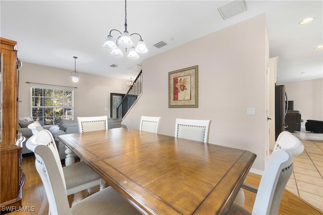 dining space featuring light tile patterned floors and a chandelier