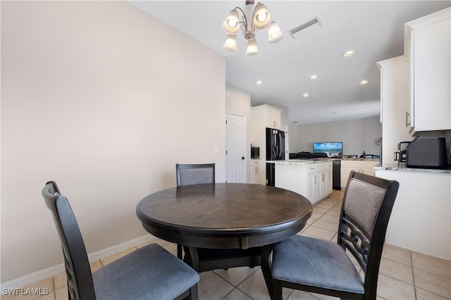 tiled dining space with a notable chandelier and sink