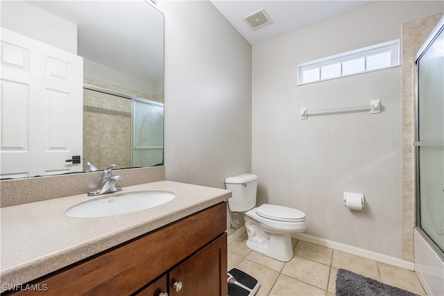 full bathroom featuring enclosed tub / shower combo, toilet, vanity, and tile patterned flooring