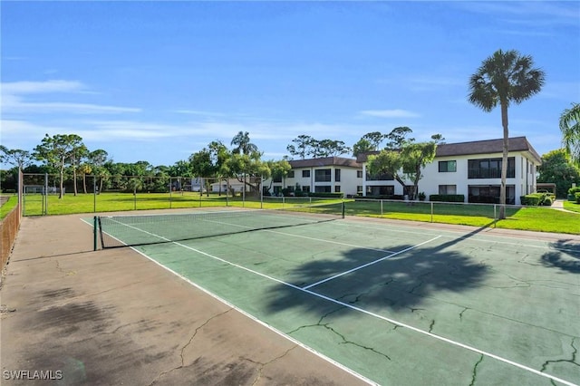 view of sport court with a lawn