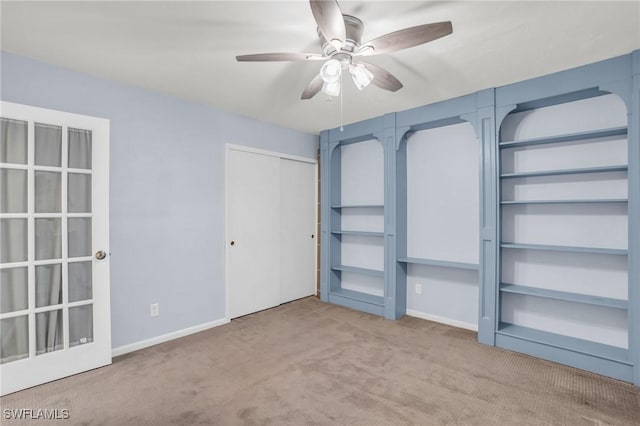 unfurnished bedroom with light carpet and ceiling fan