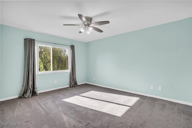 empty room featuring ceiling fan and carpet