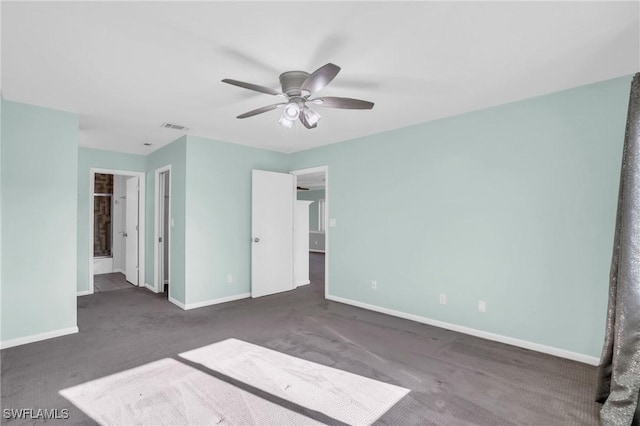 unfurnished bedroom featuring dark carpet and ceiling fan