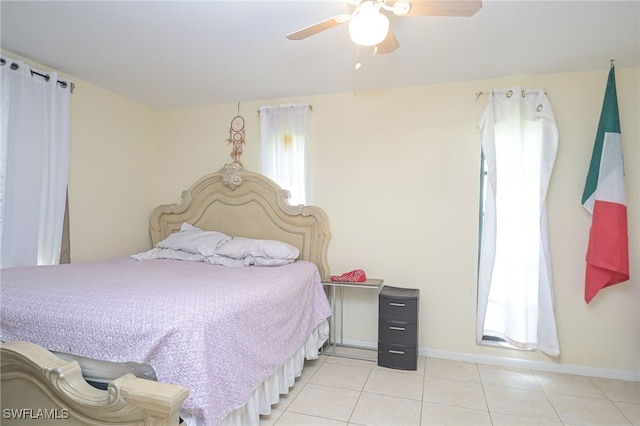 tiled bedroom featuring ceiling fan