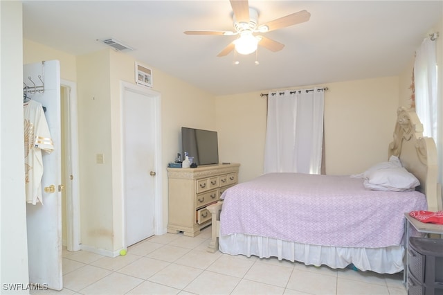 bedroom featuring light tile patterned floors and ceiling fan