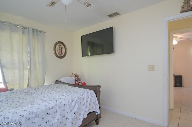 tiled bedroom with ceiling fan