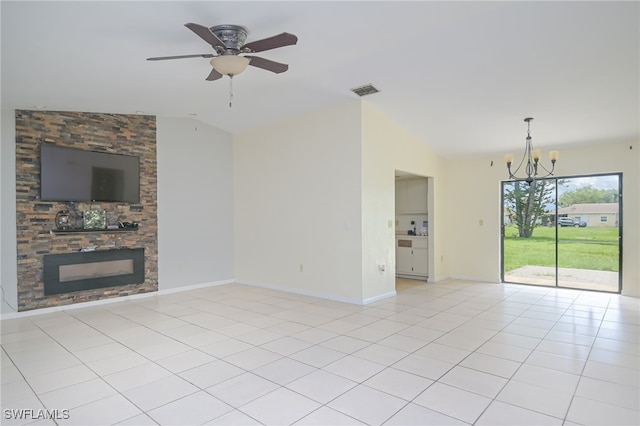 unfurnished living room with light tile patterned floors, ceiling fan with notable chandelier, a stone fireplace, and lofted ceiling