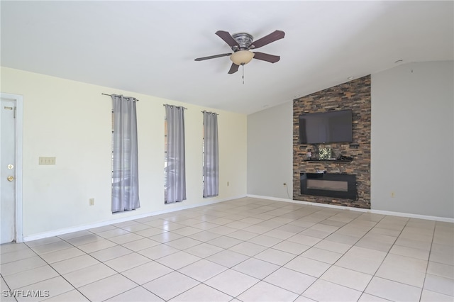 unfurnished living room with ceiling fan, a fireplace, light tile patterned flooring, and vaulted ceiling