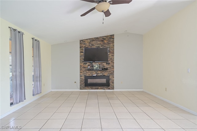 unfurnished living room featuring a stone fireplace, ceiling fan, light tile patterned flooring, and vaulted ceiling