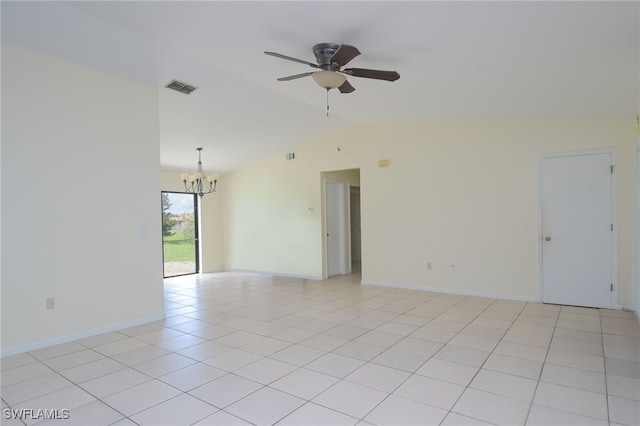 tiled spare room with vaulted ceiling and ceiling fan with notable chandelier