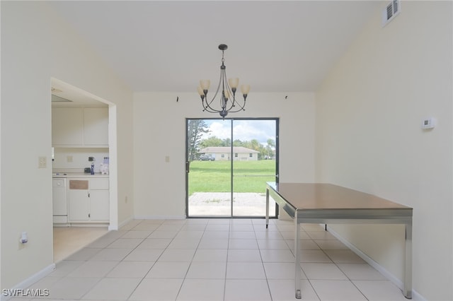 unfurnished dining area with a chandelier and light tile patterned floors