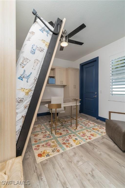 bedroom with hardwood / wood-style floors and ceiling fan