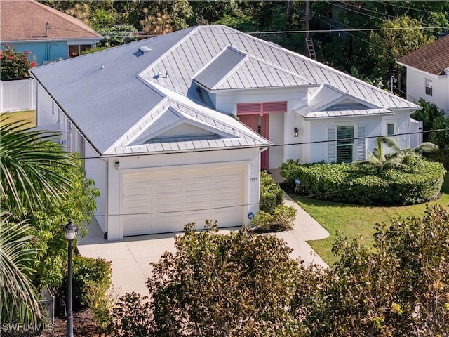 view of front of home with a garage and a front lawn