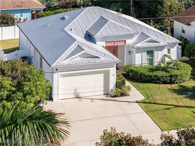 view of front of home featuring central air condition unit, a front lawn, and a garage