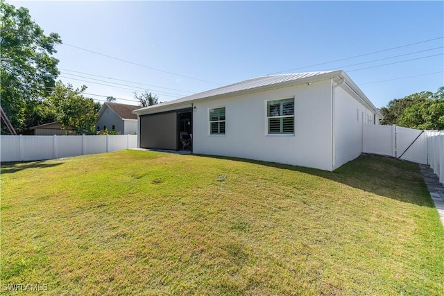 rear view of house with a lawn