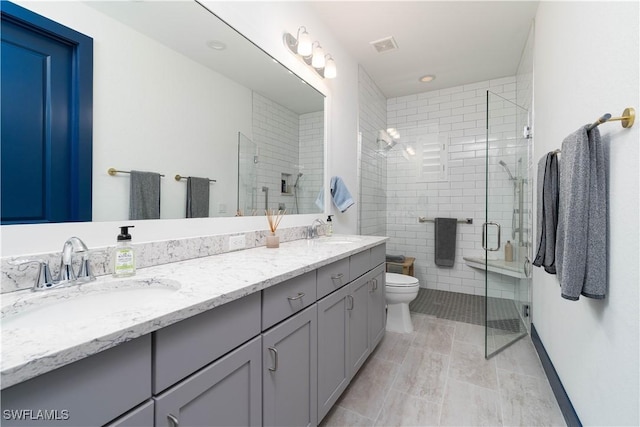 bathroom with vanity, toilet, and walk in shower