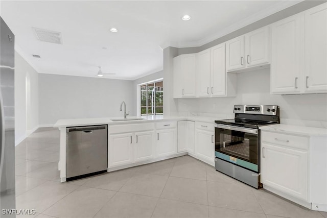 kitchen with kitchen peninsula, appliances with stainless steel finishes, ceiling fan, sink, and white cabinets