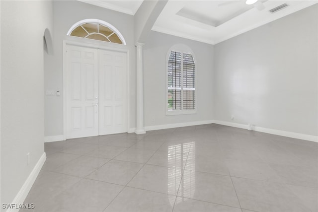 tiled foyer with ceiling fan and ornamental molding