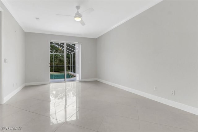 empty room with ceiling fan, light tile patterned floors, and crown molding