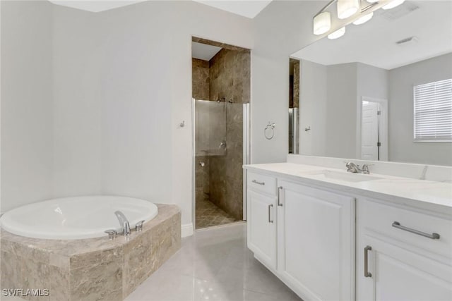 bathroom with tile patterned flooring, vanity, and shower with separate bathtub