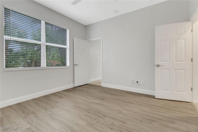 unfurnished room with light wood-type flooring