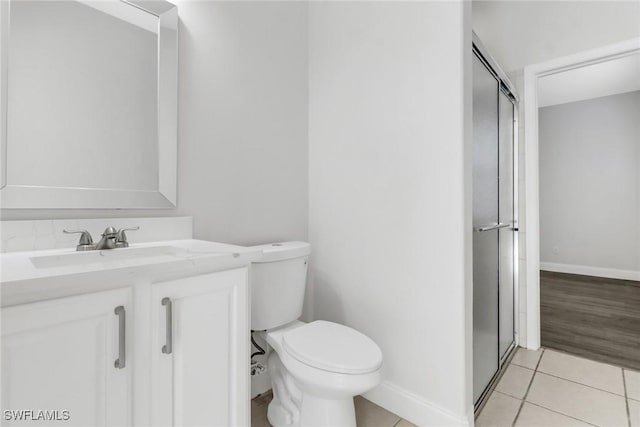 bathroom with tile patterned flooring, vanity, and toilet