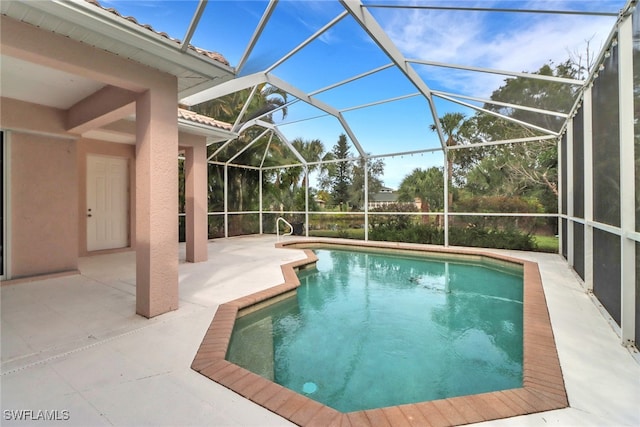 view of swimming pool with a patio and a lanai