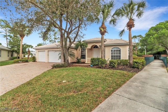 view of front of house with a garage and a front yard