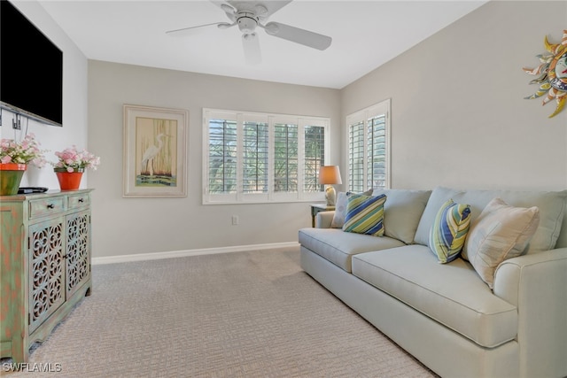 carpeted living room with ceiling fan