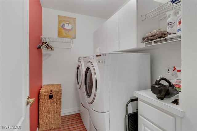 laundry room featuring cabinets and washer and dryer