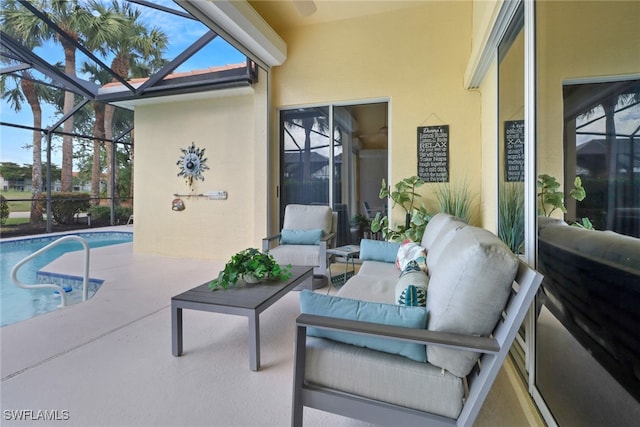 view of pool with an outdoor living space, glass enclosure, and a patio