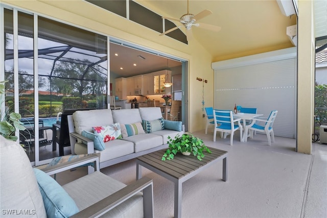 view of patio / terrace featuring outdoor lounge area, ceiling fan, and a lanai