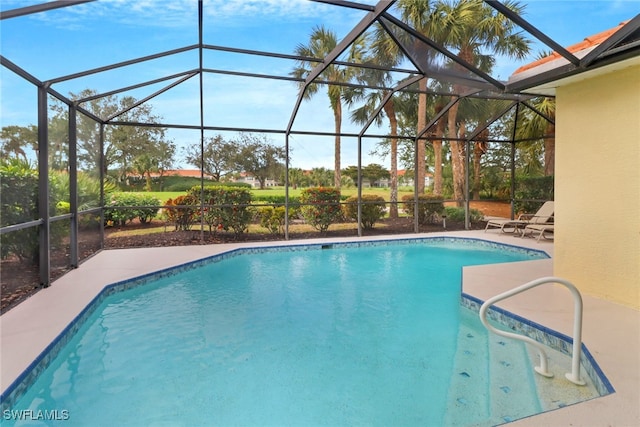 view of pool with glass enclosure and a patio