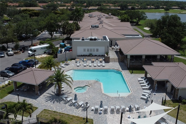 view of swimming pool with a water view and a patio